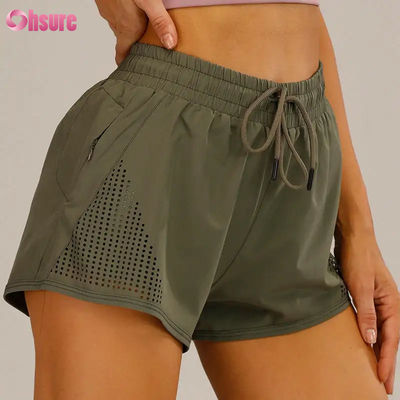 Pantalones cortos deportivos de entrenamiento para mujer al por mayor, transpirables, con corte láser, para correr, con bolsillo lateral con cremallera para calentamiento, patrón sólido